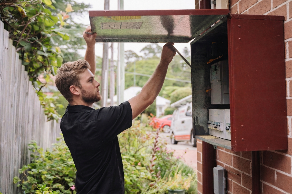 Electrician installing downlights in a Miranda home